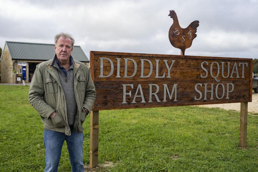 Jeremy Clarkson standing outside the sign for his Diddly Squat Farm Shop in the Cotswolds